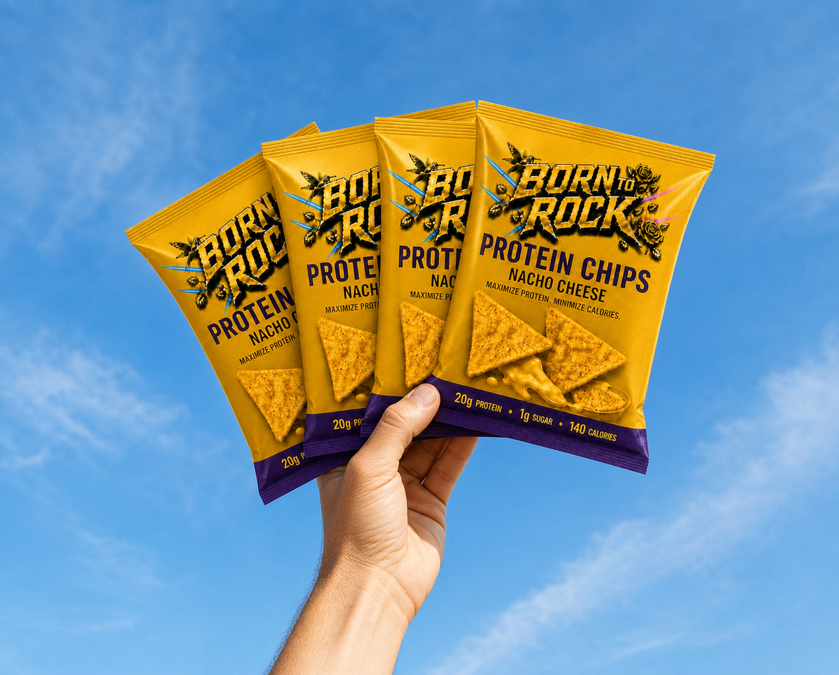 A raised hand holding four bags of Born To Rock Protein Chips fanned out against a blue sky
