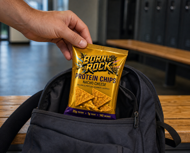 A hand lifting the bag out of an open backpack on a changing bench at the gym