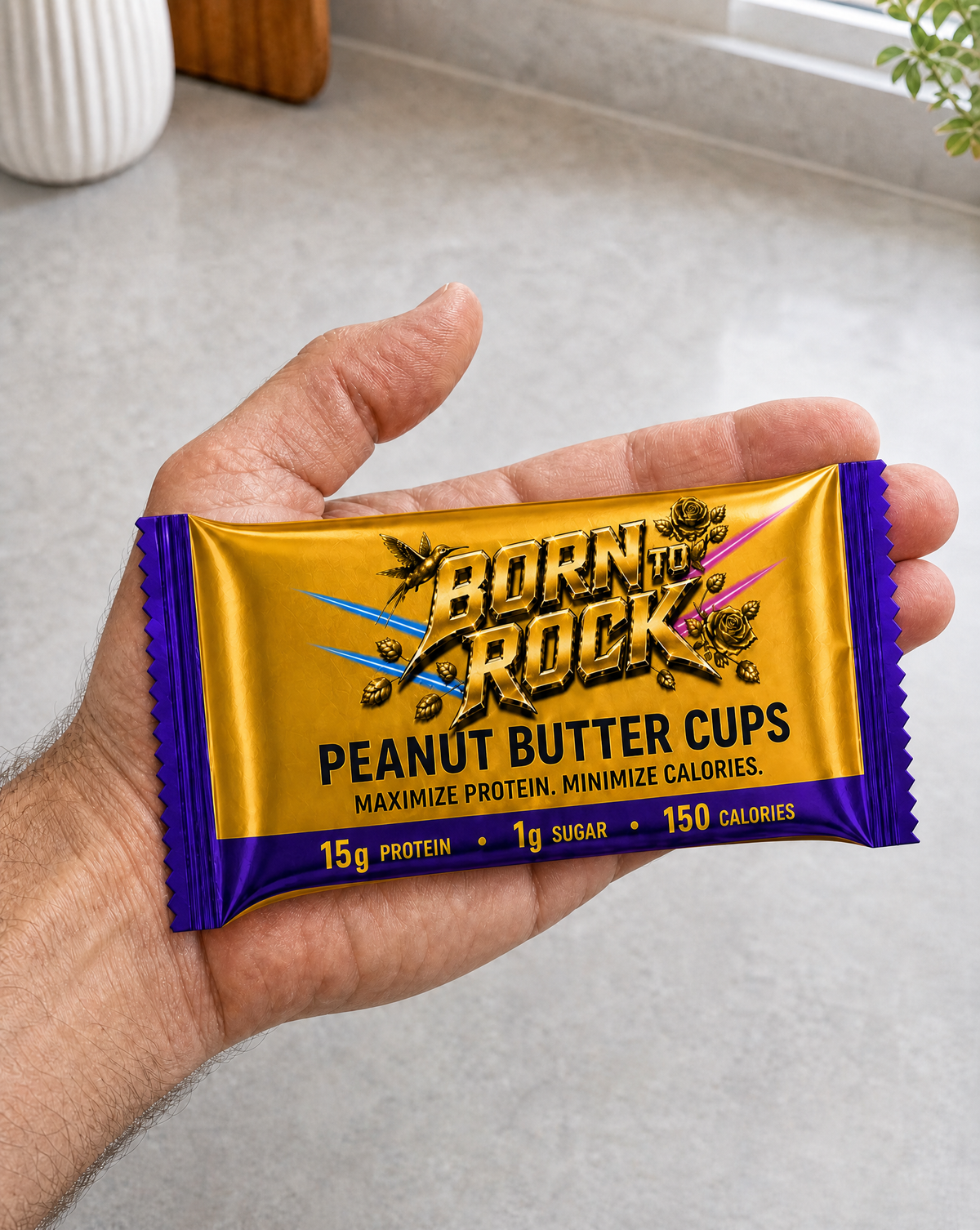 Born To Rock Peanut Butter Cups pouch resting across an open palm for scale, overhanging the hand at both ends
